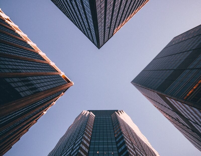 low-angle photography of four high-rise buildings